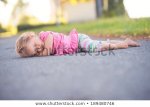 little-girl-sleeping-on-road-450w-189480746.jpg