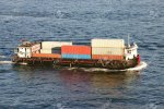 3491326-a-small-shipping-barge-taking-containers-across-the-harbour-hong-kong.jpg